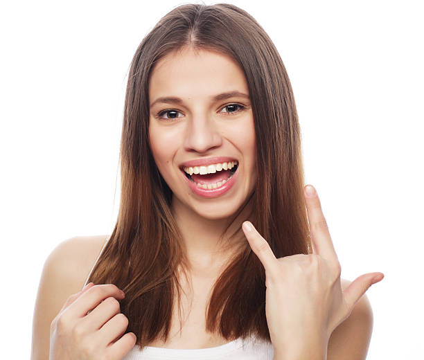 istock happy woman poiting finger up at copyspace isolated on a white 2251909532