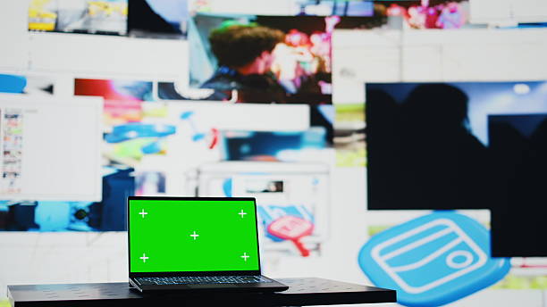 istock Laptop shows green screen mockup next to modern web design 2251911618