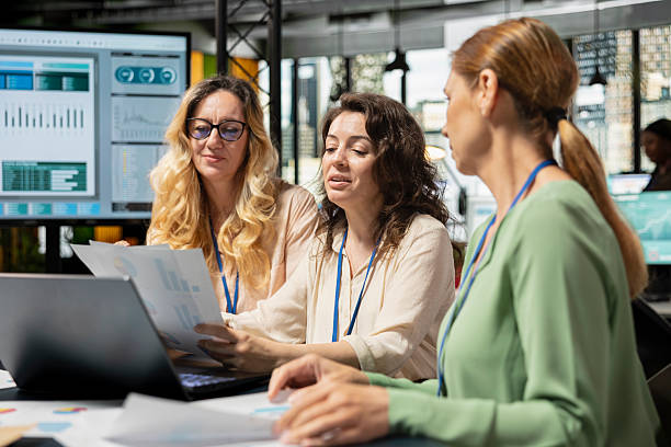 istock Empowered businesswomen evaluating graphs and strategy reports 2251913846