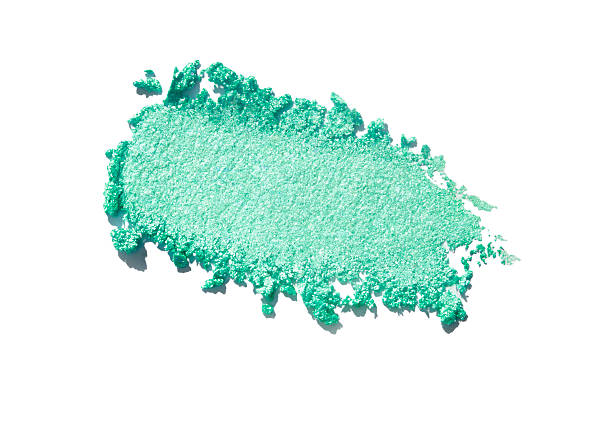 Vibrant crushed green eyeshadow with shimmering metallic texture on a white background. Perfect for beauty, cosmetics, makeup, and fashion concepts. Luxurious and artistic detail.