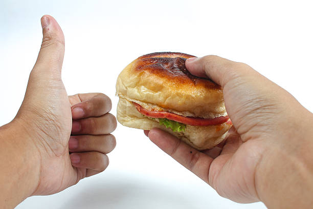 Close up Man Hands Holding Tasty Hamburger with Thumb Up Gesture