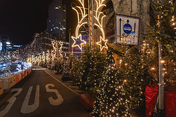 Berlin, Germany – December 2, 2025: Decorated Christmas trees and illuminated star-shaped light installations line Kurfuerstendamm during the winter holiday season.