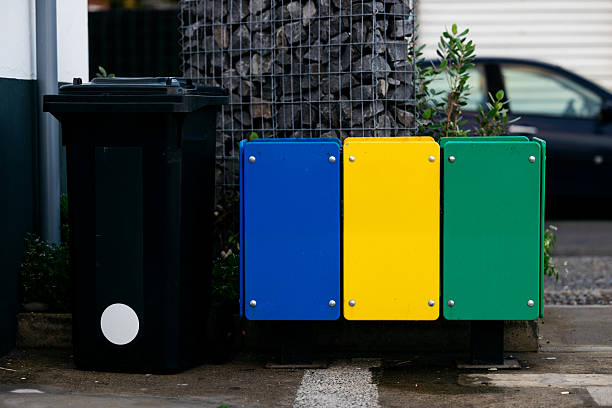 istock Waste management system featuring a black trash bin alongside colorful recycling bins in blue 2251918008