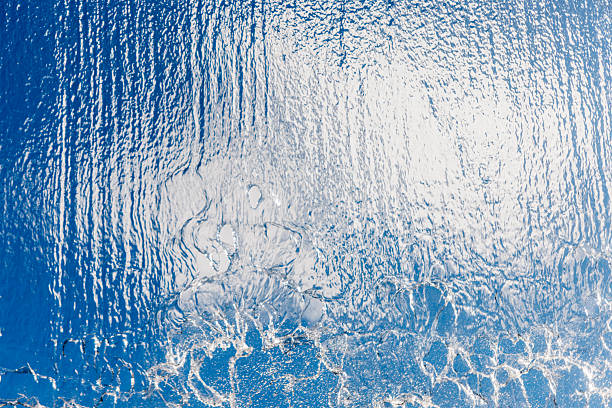 istock Blue water surface with shimmering reflections and gentle waves 2251918062