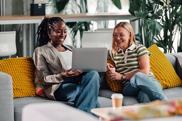 istock Diverse colleagues collaborating on laptop in modern office lounge 2251918338