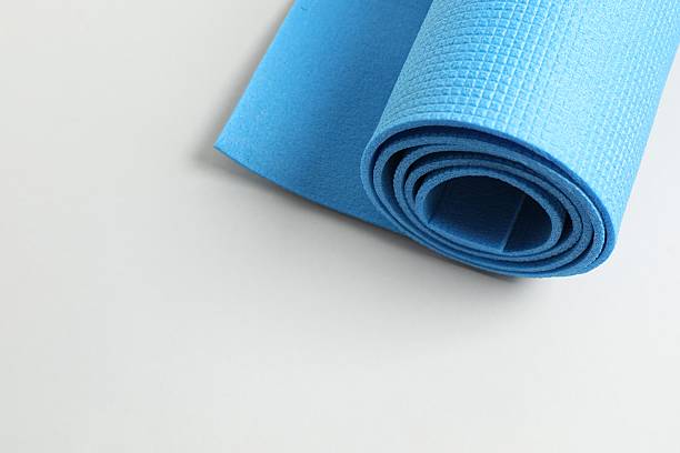istock Blue mat folded into a roll, karemat for camping, on color background 2251918609