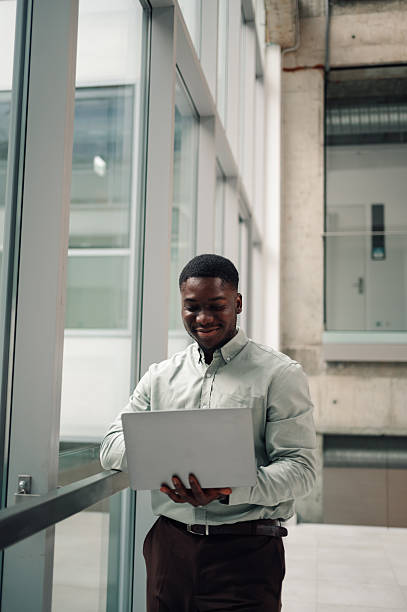 istock Young black man working on laptop in modern office 2251918668