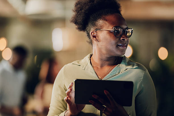 istock Black businesswoman using digital tablet working late 2251918852