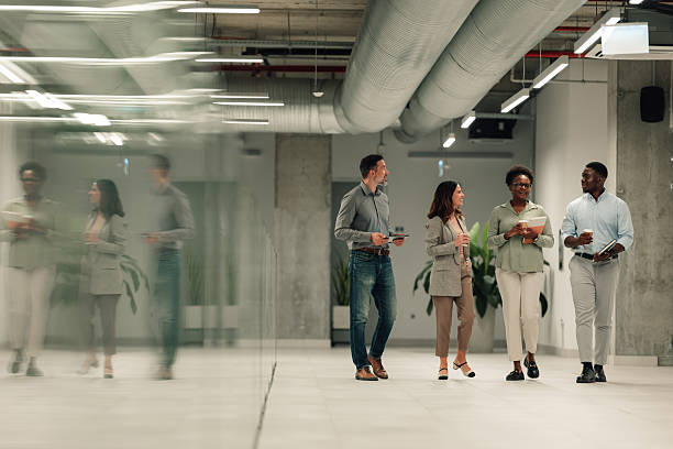 istock Diverse business team walking through office hallway 2251918884