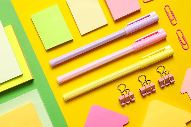 Various colorful school supplies with notebook placed neatly on color background