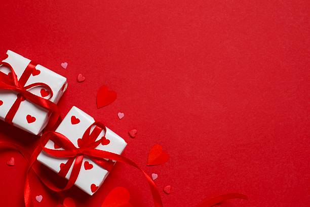istock Festive gift boxes with red hearts on red background. Valentines day, Birthday or Wedding romantic concept. Festive composition. Mock up 2251920176