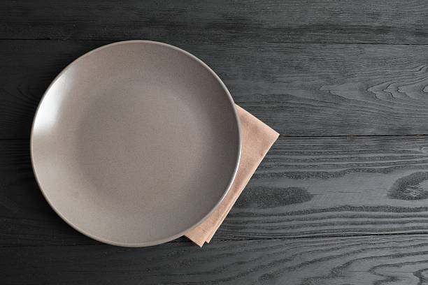 istock Empty round plate on wooden background, top view 2251920434
