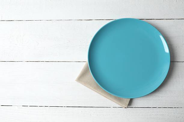 Empty round plate on wooden background, top view