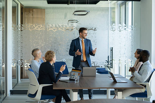 istock Businessman leading meeting with team in modern office 2251920562