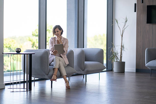 istock Businesswoman using digital tablet in modern office lobby 2251920572