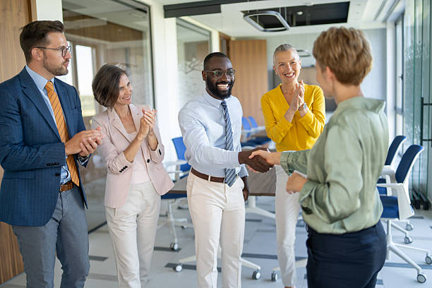 istock Business team congratulating new partner with handshake in modern office 2251920573