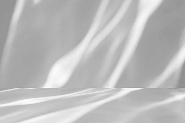 istock Abstract white studio room with light and shadow from window background for product display presentation 2251920736