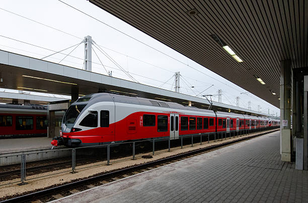 istock Modern red train at urban station platform 2251921120