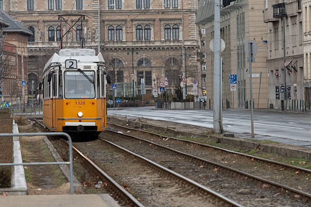 istock Yellow vintage tram approaching on city tracks 2251921121