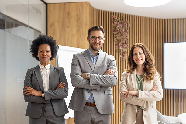 istock Confident business team smiling with arms crossed in modern office 2251921406