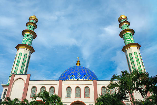 istock A mosque standing majestically against a beautiful blue cloud background 2251921724