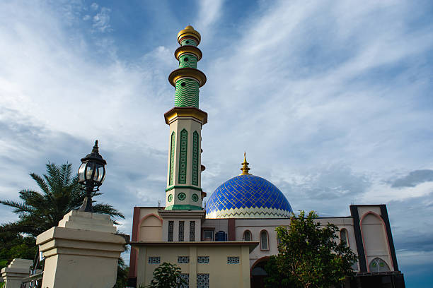 istock A mosque standing majestically against a beautiful blue cloud background 2251921729