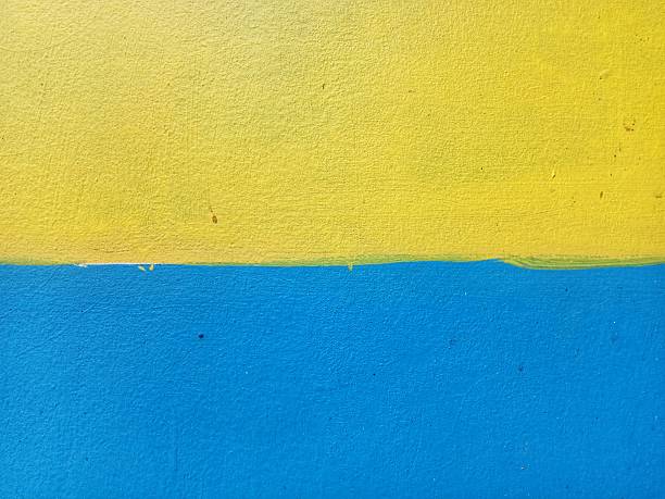 istock wall paint in two colors yellow and blue, colored background 2251922544