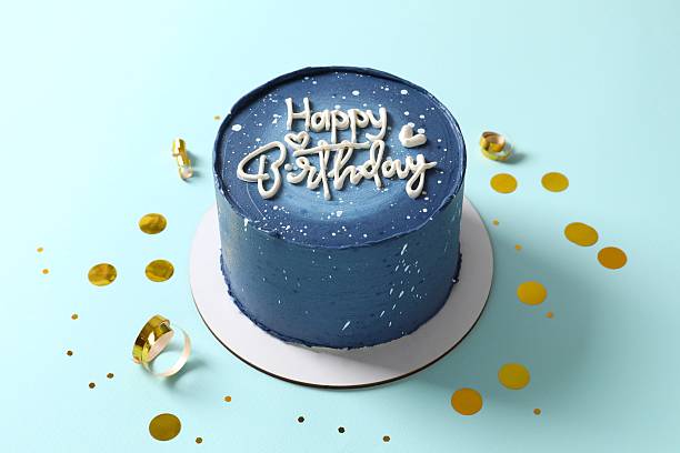 Birthday cake on blue background, top view