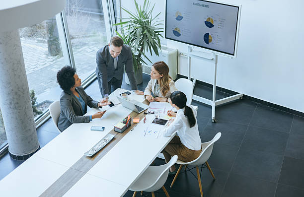 istock Team reviews business data on digital presentation 2251924474