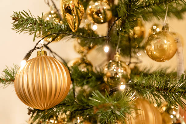 istock Decorated Christmas tree with golden ornaments and warm lights 2251924570