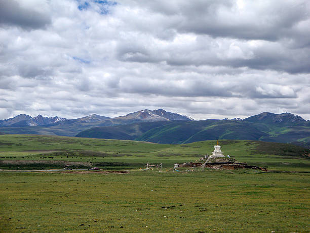 istock Vast Grassland with Stunning Mountain Range and White Pagoda 2251925526