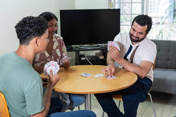 istock Friends playing card game at home together 2251926874