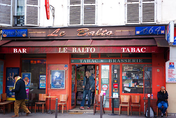 Paris, France - October 31, 2025: Men at Le Balto, an old-fashioned bar-tabac on Rue Oberkampf in the 11th arrondissement.
