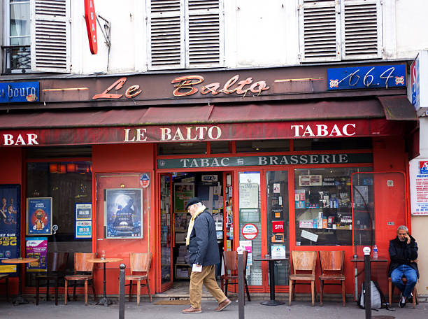 Paris, France - October 31, 2025: Men at Le Balto, an old-fashioned bar-tabac on Rue Oberkampf in the 11th arrondissement.