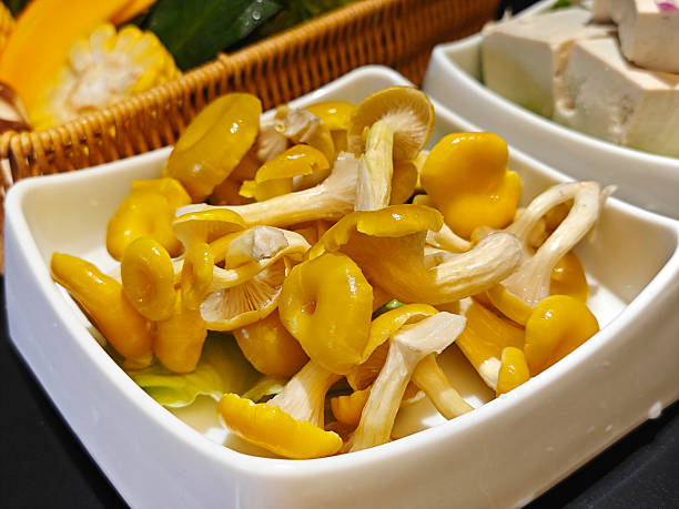 fresh mushrooms on the white plate ready for cooking