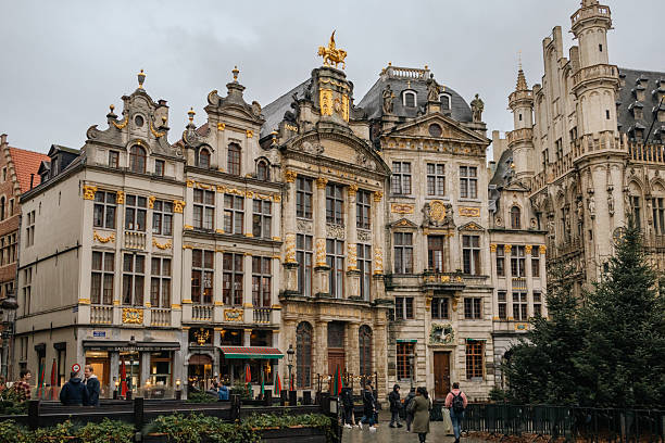 Illuminated, traditional style buildings along the Grand Place in central Brussels, Belgium. Photo taken during a cloudy winter day