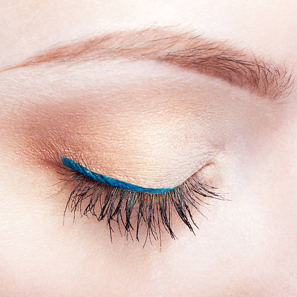 Macro profile of blue, sparkle glitter eye with eyelashes and eyebrow in close detailed, macro shot.