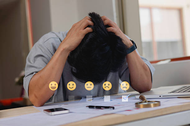 customer service evaluation and feedback rating. costumer review concept, man using phone chooses angry face