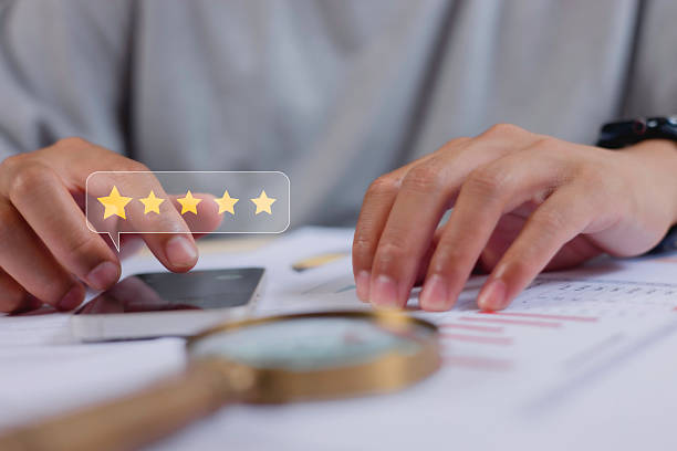 customer service evaluation and feedback rating. costumer review concept, man using phone chooses happy smiling face