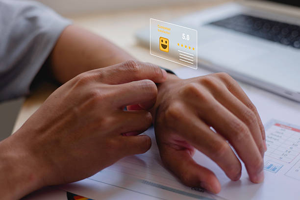 istock customer service evaluation and feedback rating. costumer review concept, man using phone chooses happy smiling face 2251938078