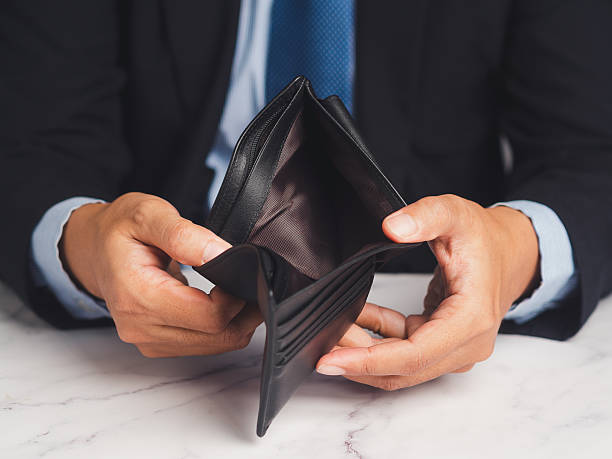 istock Man holding empty wallet showing money shortage. 2251939985