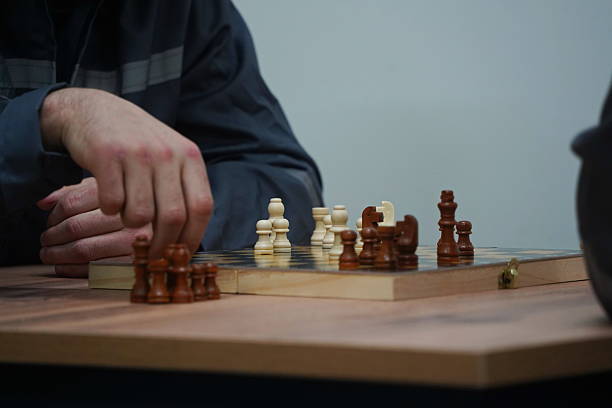 istock Prisoners are playing chess in their cell. The colony. 2251940113