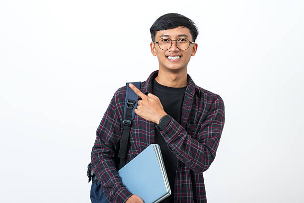 istock Young college student pointing with finger showing something on white background 2251940631
