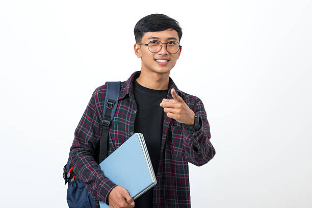 istock Young college student pointing with finger showing something on white background 2251940632