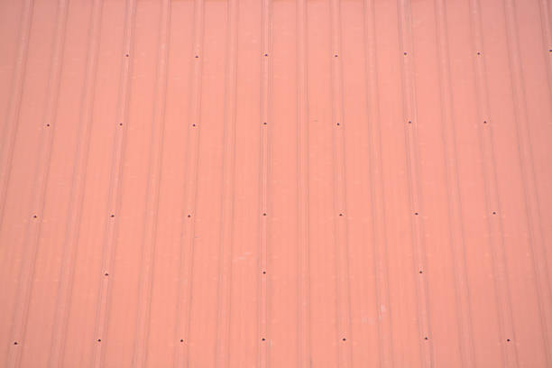 istock Pale Red Corrugated Steel: Architectural Background, Clean Linear Geometry and Warm Tones. 2251942060