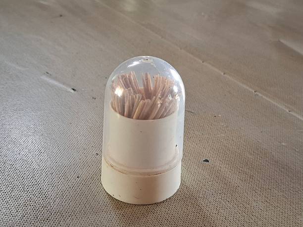 A matchstick is a small, slender stick with a combustible head. Striking it against a rough surface ignites the head, producing a flame used to light candles, stoves, or fires.