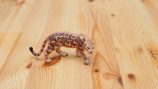 istock Leopard figurine home setup toy wooden surface close-up creative display 2251943010