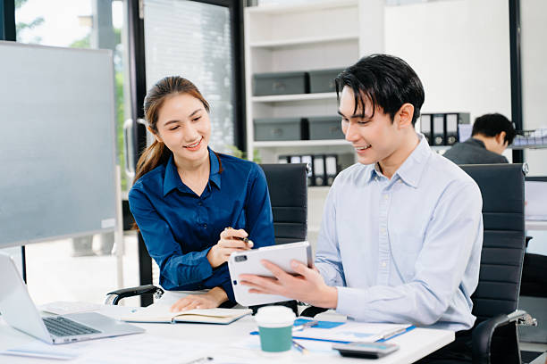 istock Young Asian professionals collaborating in modern office, discussing business strategy, teamwork, and success. Perfect for corporate, startup 2251946201
