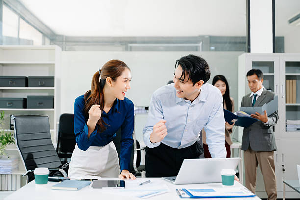 istock Joyful Asian business team celebrating success in a modern office, symbolizing teamwork, motivation, and achievement in corporate culture. 2251946214