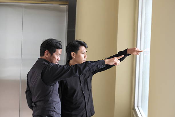 istock Businessmen Pointing Out Window Discussing Future Vision 2251957324